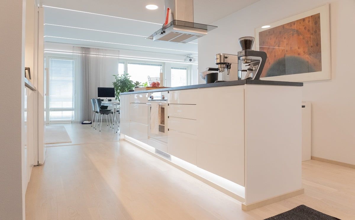 LED strip illuminating the plinth of a kitchen island as accent lighting. ©LedStore