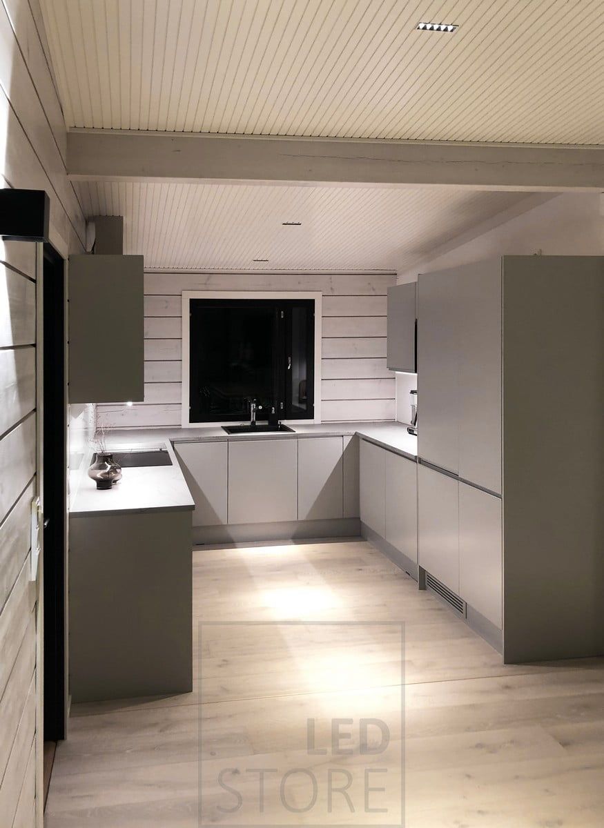 LINJA 5 spots in the kitchen ceiling. Countertops illuminated by LED strips fixed to the bottom of the upper cabinets. Ledstore.fi