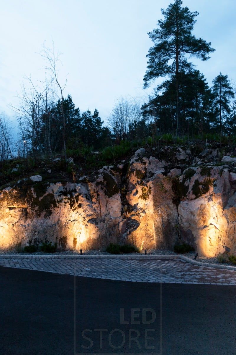 SPIKE ground lights illuminating a rock with atmospheric, indirect light. Ledstore.fi