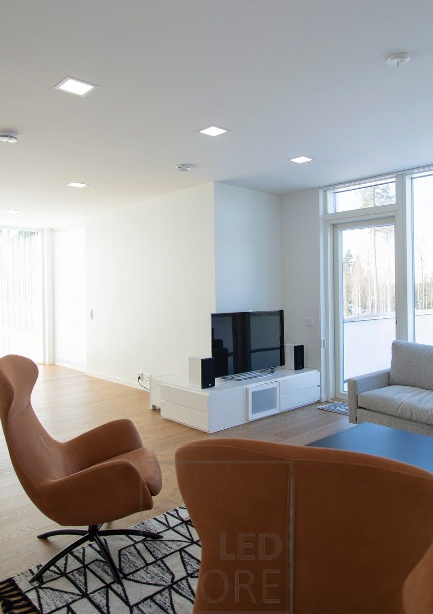 Minimalist panel lights blend beautifully with the white ceiling, evenly illuminating the living room. The modern design language goes well with the Scandinavian interior. Ledstore.fi