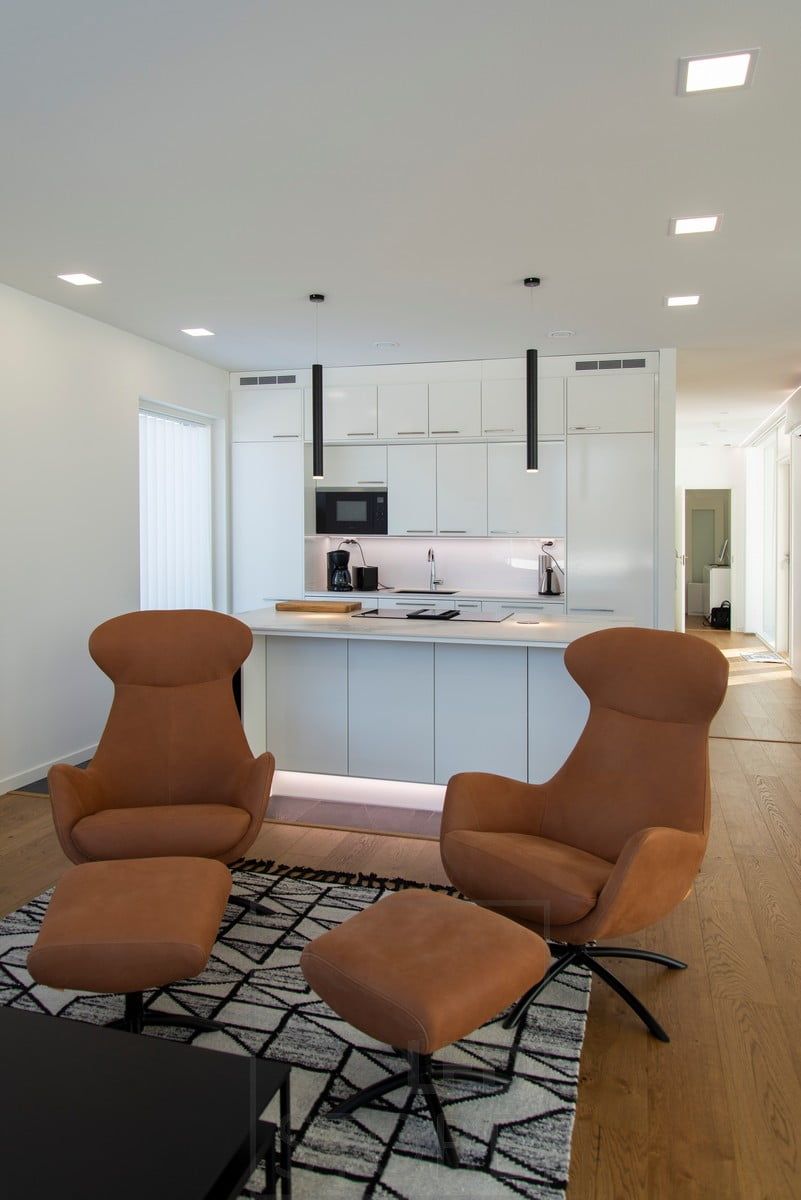 The open-plan kitchen and living room are lit by ceiling luminaires. The island is accentuated and illuminated by pendant pendant lights. Ledstore.fi