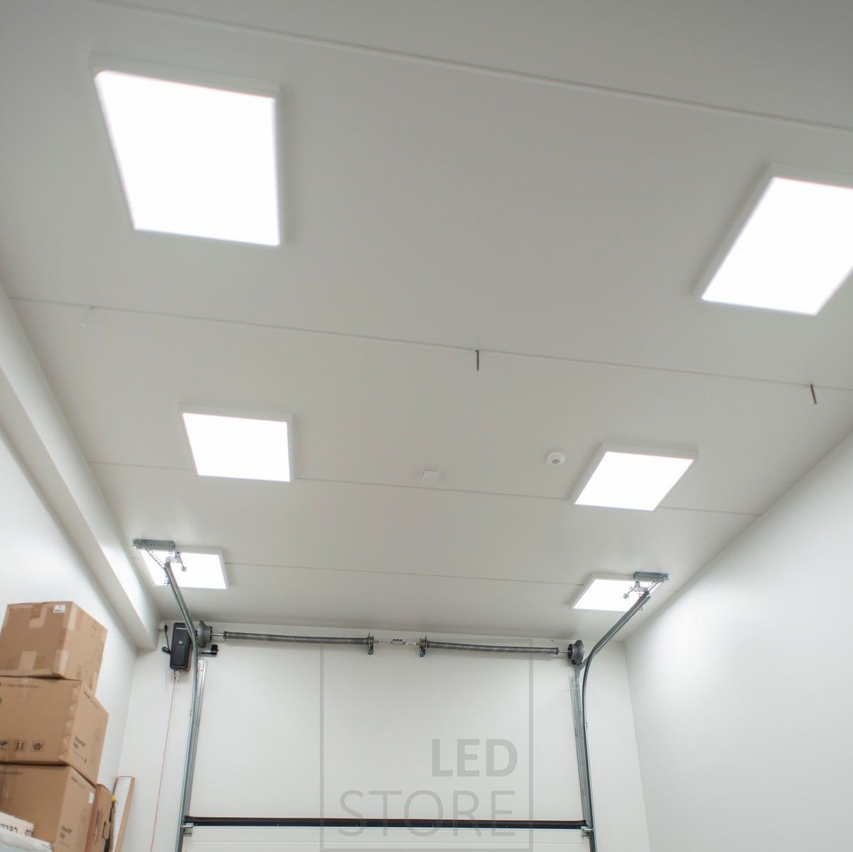 600x600 panels in surface frames on a warehouse roof. The lighting is adaptable and efficient, with no dark corners in the space. Ledstore.fi