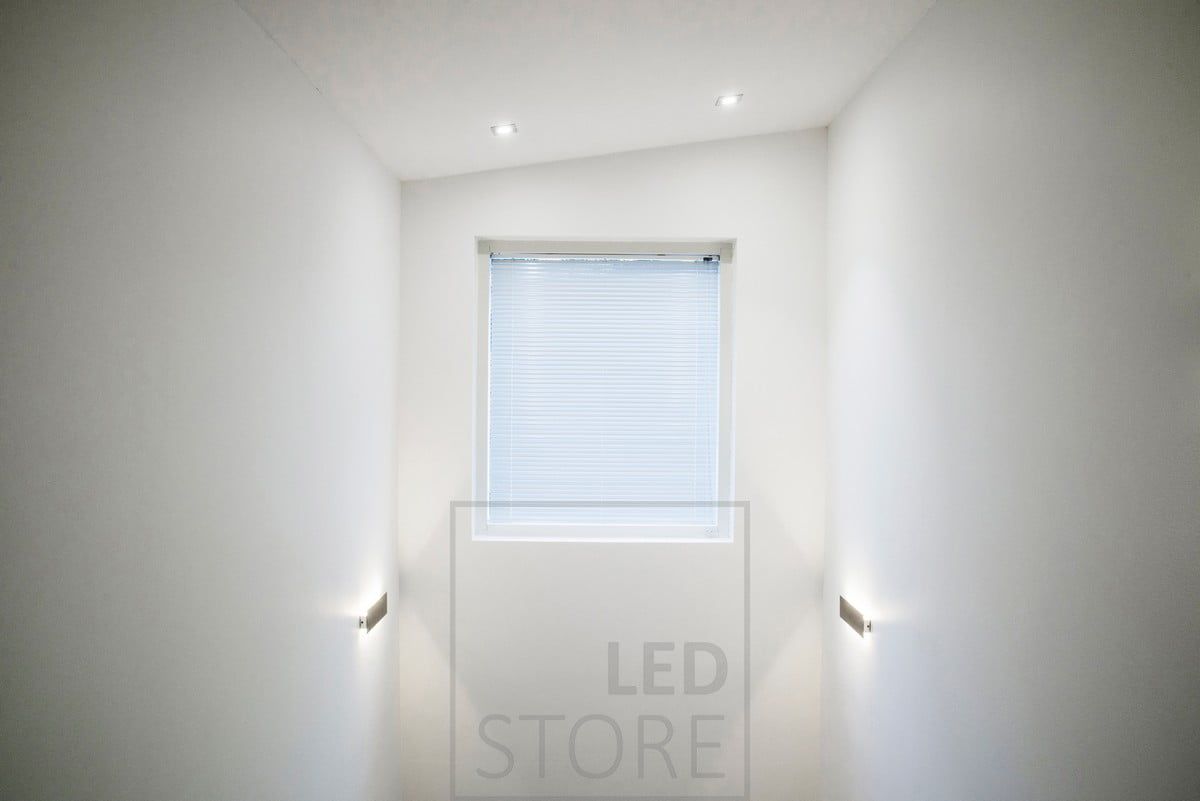 STRAIGHT wall light providing atmospheric, indirect light, bringing mood lighting to a high ceiling space through the walls. Ledstore.fi