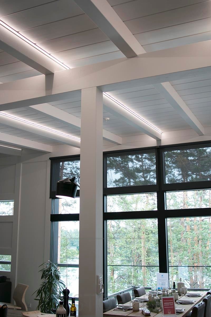 LED strips mounted on corner profiles to highlight the beams. Ledstore.fi