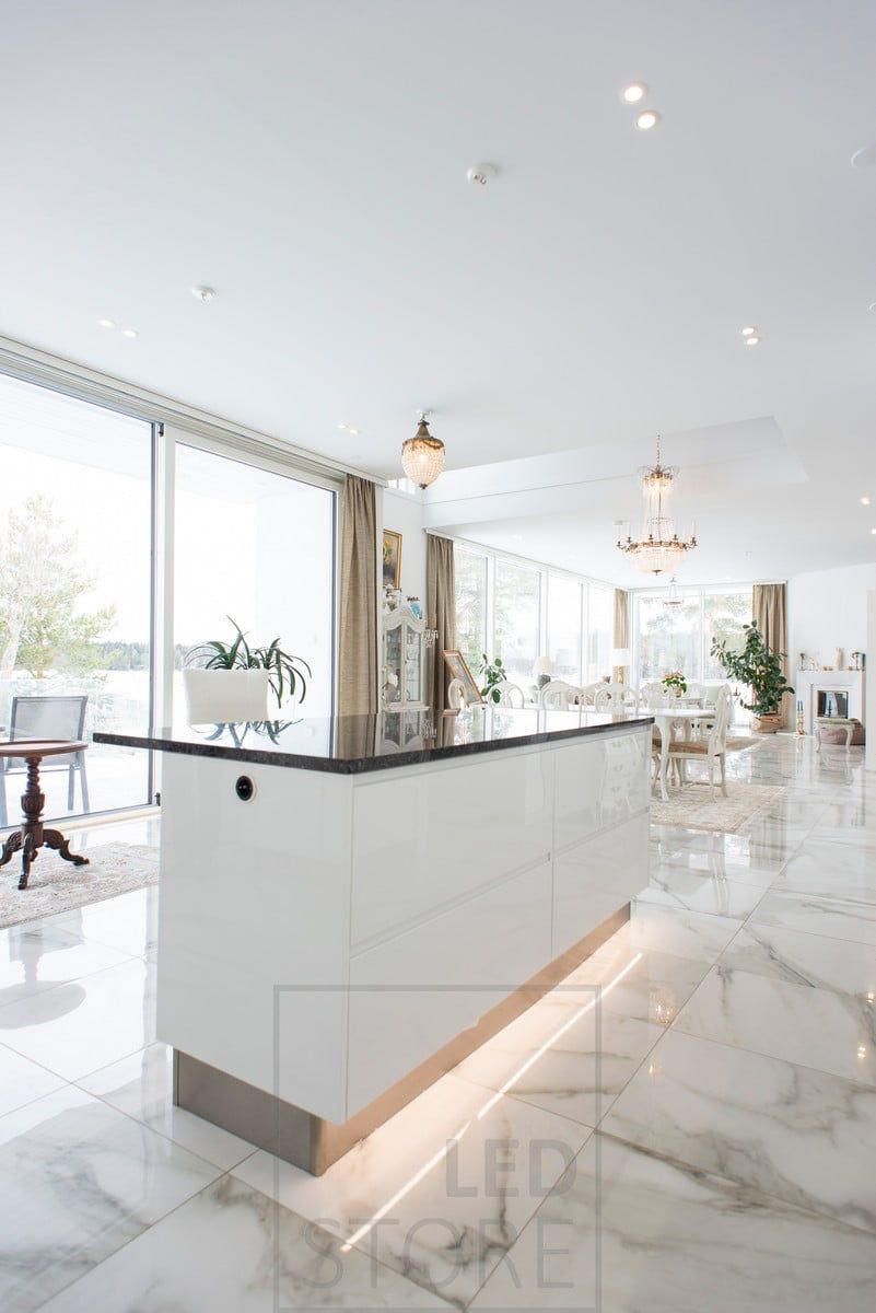 A beautiful kitchen island accented with an LED strip at the base of the island. Ledstore.fi