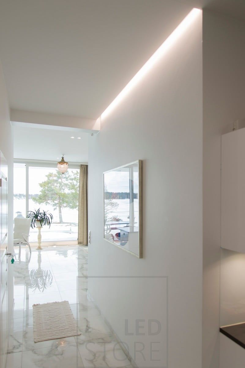 Highlighting and illumination of a table and a corridor with LED strip. Led strip hidden in a groove between ceiling and wall. Ledstore.fi