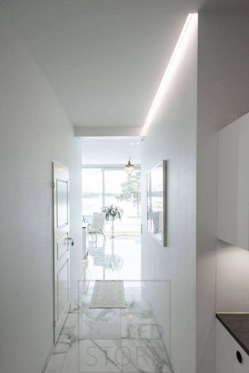 Highlighting and illumination of a table and a corridor with a led strip in a groove between the ceiling and the wall. Ledstore.fi