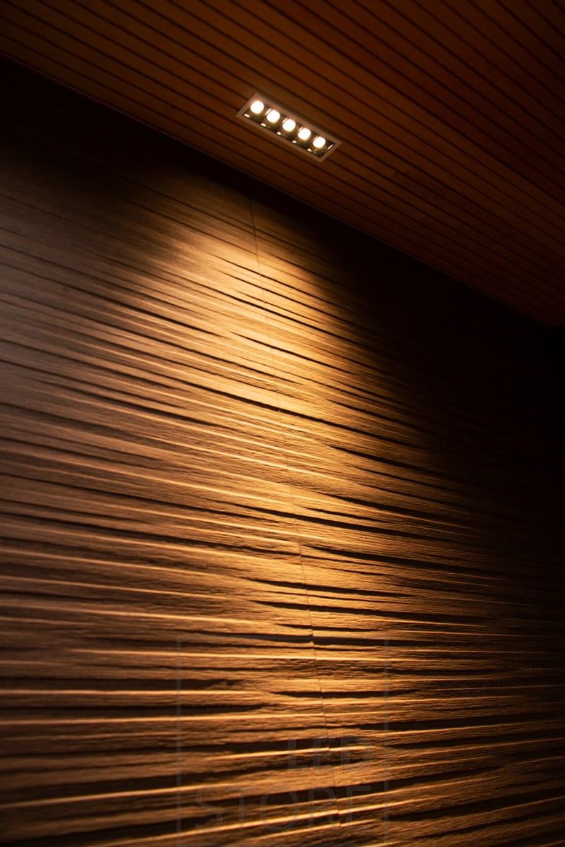 LINJA5 highlighting the texture of the ceiling on the wall. Ledstore.fi