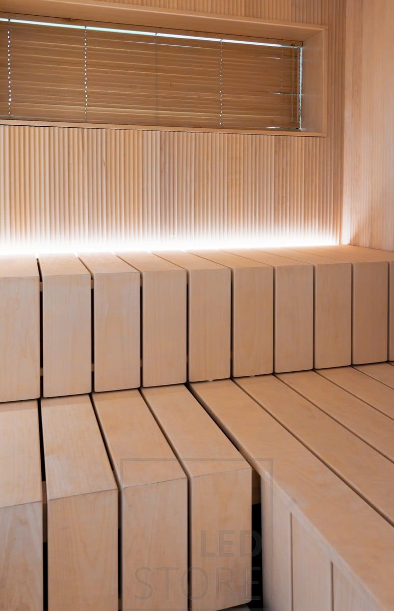 In the sauna, a led strip light in the groove behind the bench, pointing upwards. Ledstore.fi