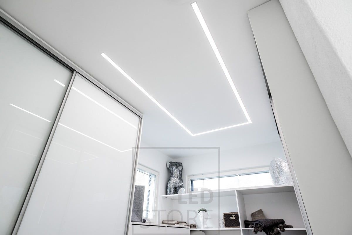 Led strip lights in a wide recessed profile illuminating a wardrobe. The profile rotates around the room so that the light is directed where it is needed. Ledstore.fi