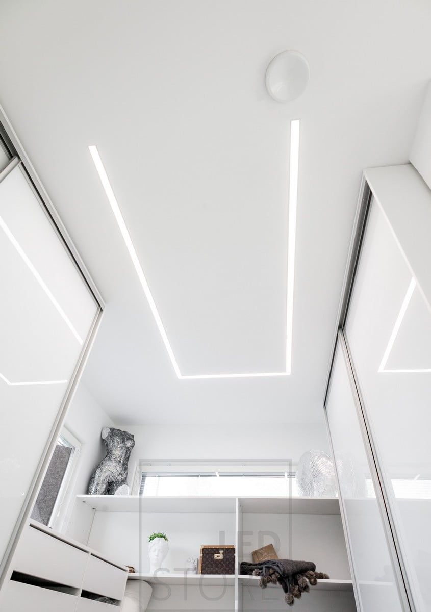 Led strips in a wide flush profile illuminating a wardrobe. The profile rotates around the room so that the light is directed where it is needed most. Ledstore.fi