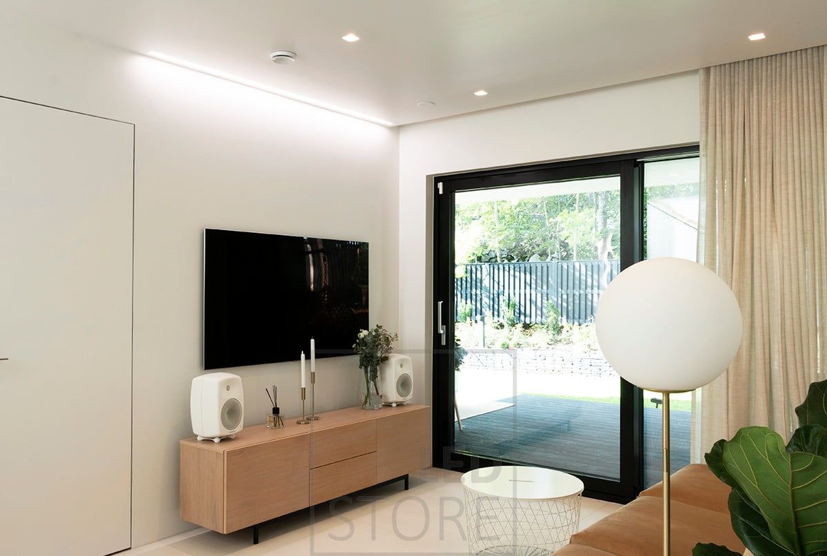 A wide flush-mounted profile next to a wall creates atmospheric general and indirect light. Ledstore.fi