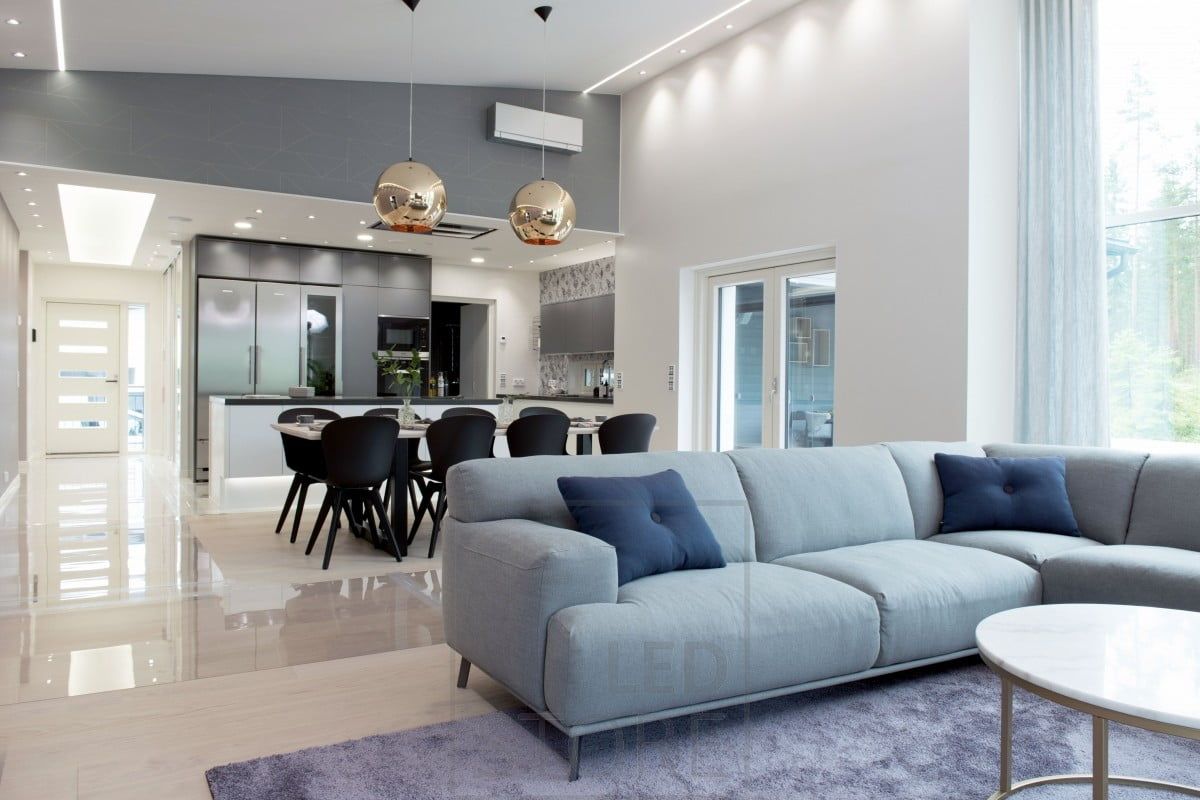 Versatile lighting - led strip in narrow uplight profile, small spots near the wall for mood lighting, in the kitchen effective lighting with plafonds and spotlights. On the dining table, two impressive pendant lights. Ledstore.fi