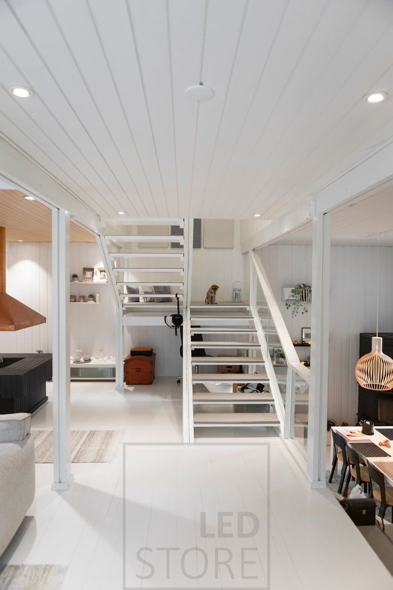 Round, white LED spotlights provide even and atmospheric lighting for the downstairs living area. Ledstore.fi