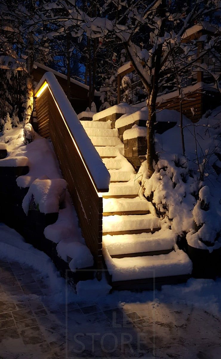 Exterior staircase lighting implemented with LED strip on the balustrade. The light is atmospheric indirect light, the LED strip used is a warm 3000K 7,2W/m strip. Ledstore.fi