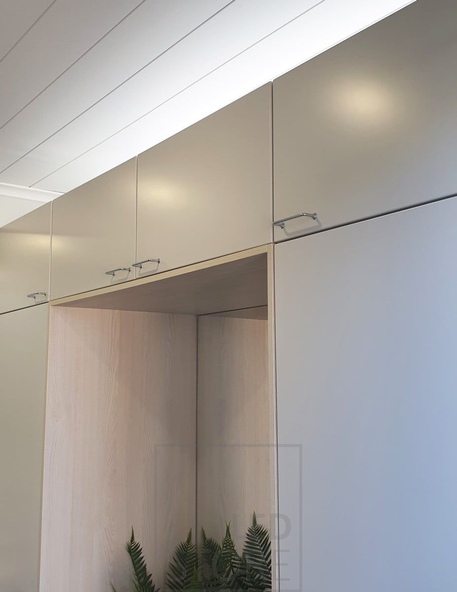 On top of the wardrobes, an LED strip light in aluminium profile creates indirect mood lighting in the hallway. Ledstore.fi