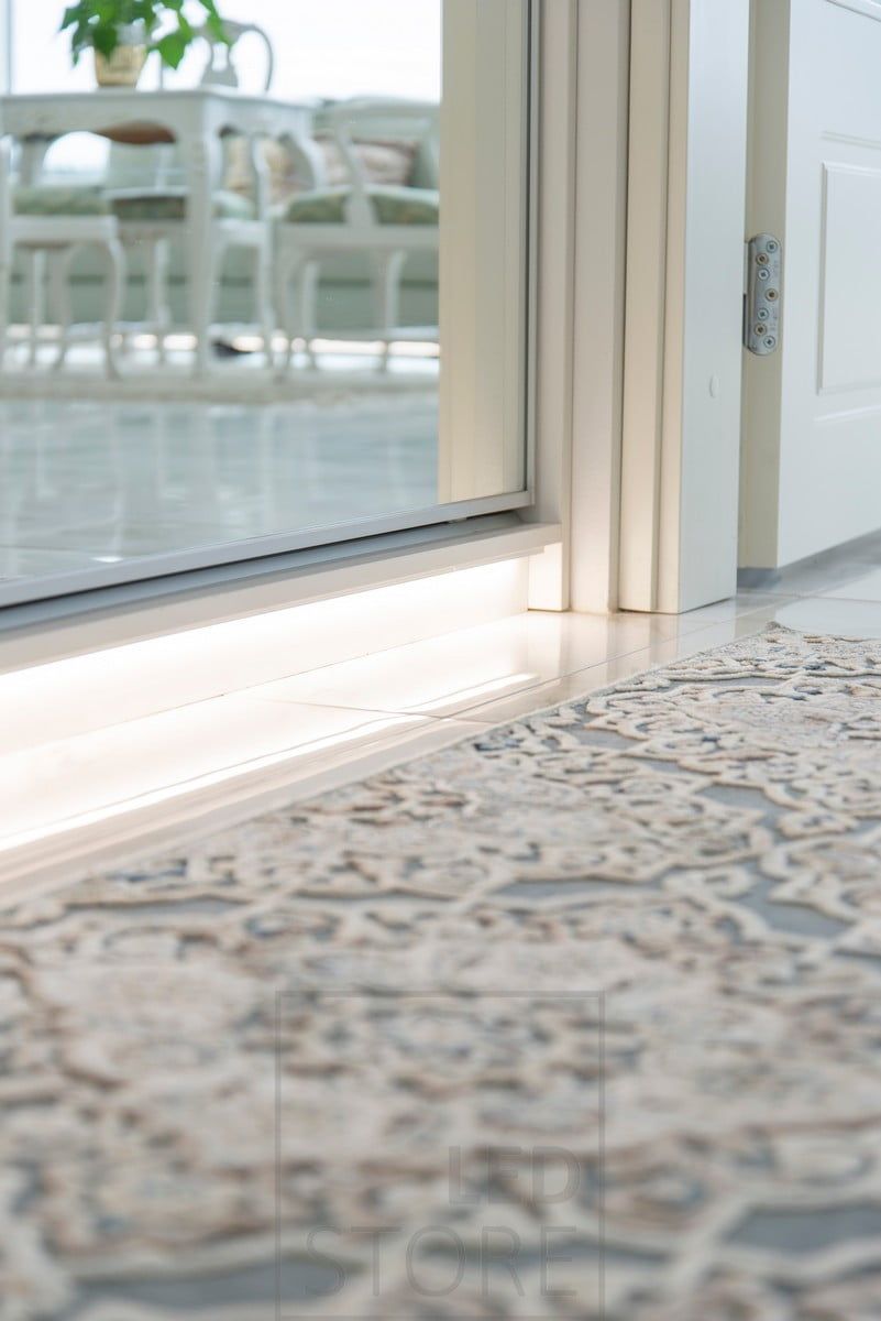 A LED strip of light at the base of the hallway wardrobe, creating indirect light through the floor into the hallway. Ledstore.fi