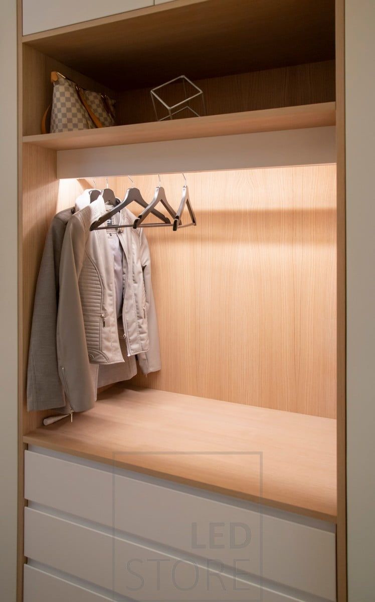 A wardrobe with a led strip light illuminating the contents of the wardrobe with indirect light. Ledstore.fi