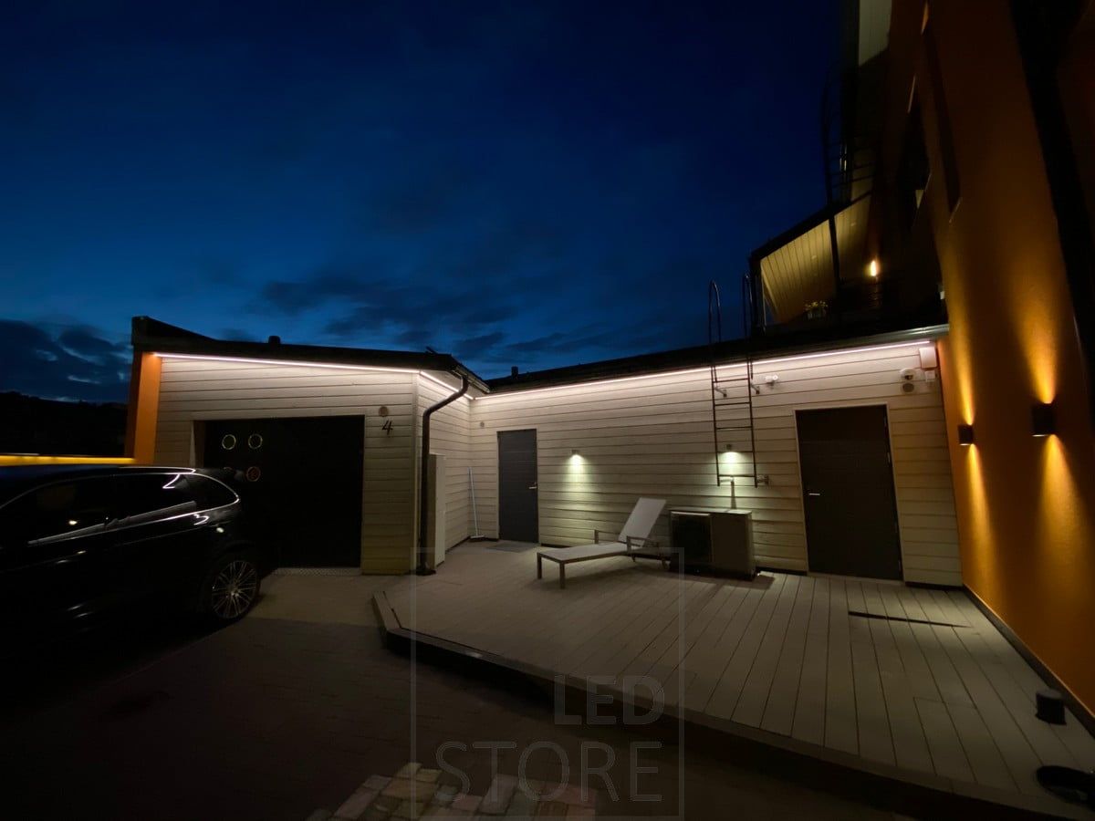 Led strip on eaves illuminating the facade of a garage and warehouse with indirect light. Ledstore.fi