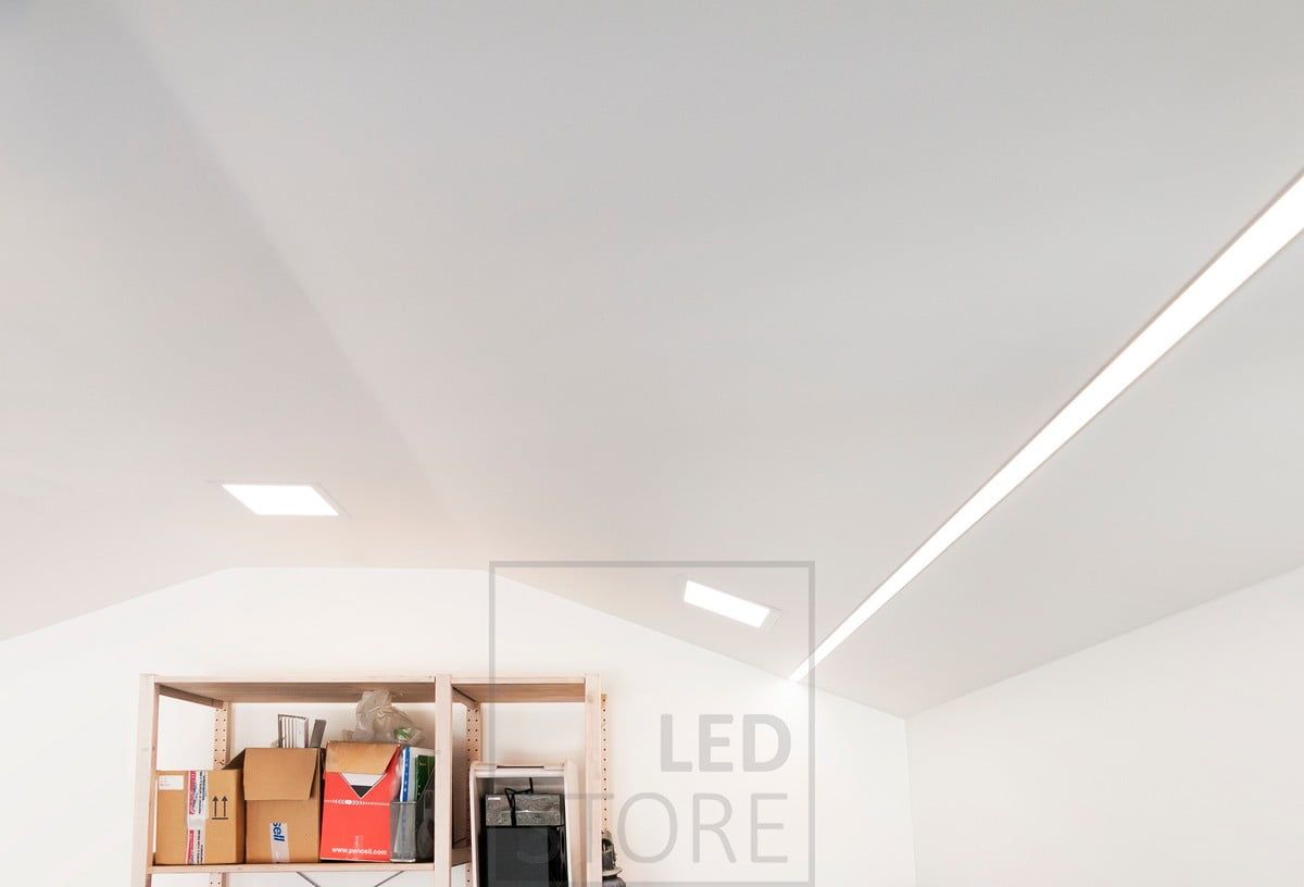 Recessed panel luminaires combined with wide recessed profiles on the sides of the room. Two LED strips inside the profile. Ledstore.fi
