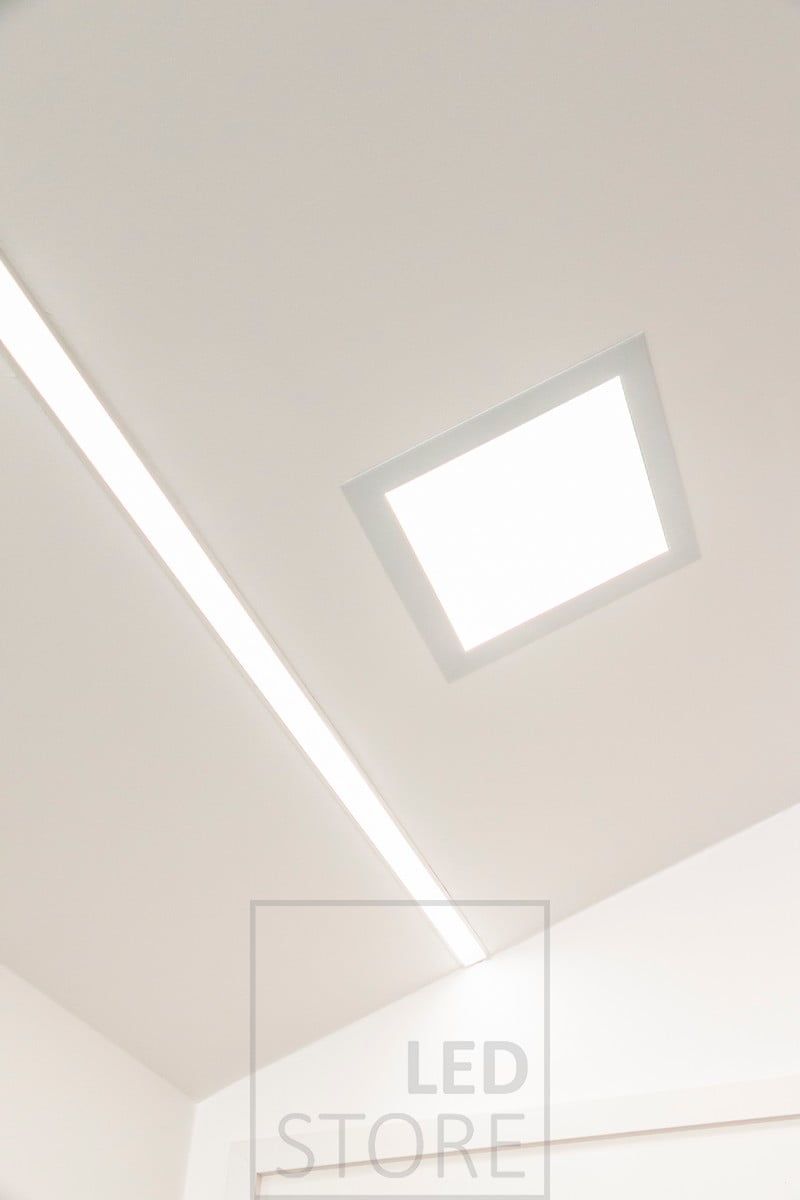 Recessed panel luminaire combined with a wide recessed profile. Ledstore.fi