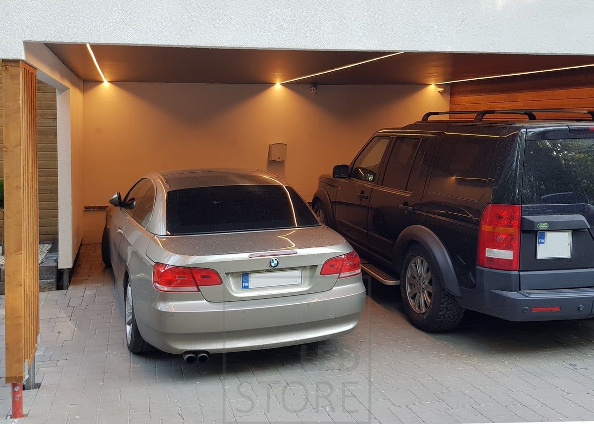 On the roof of a carport, LED strips in a narrow surface profile illuminate the sides of cars and bring light where you need it. Ledstore.fi