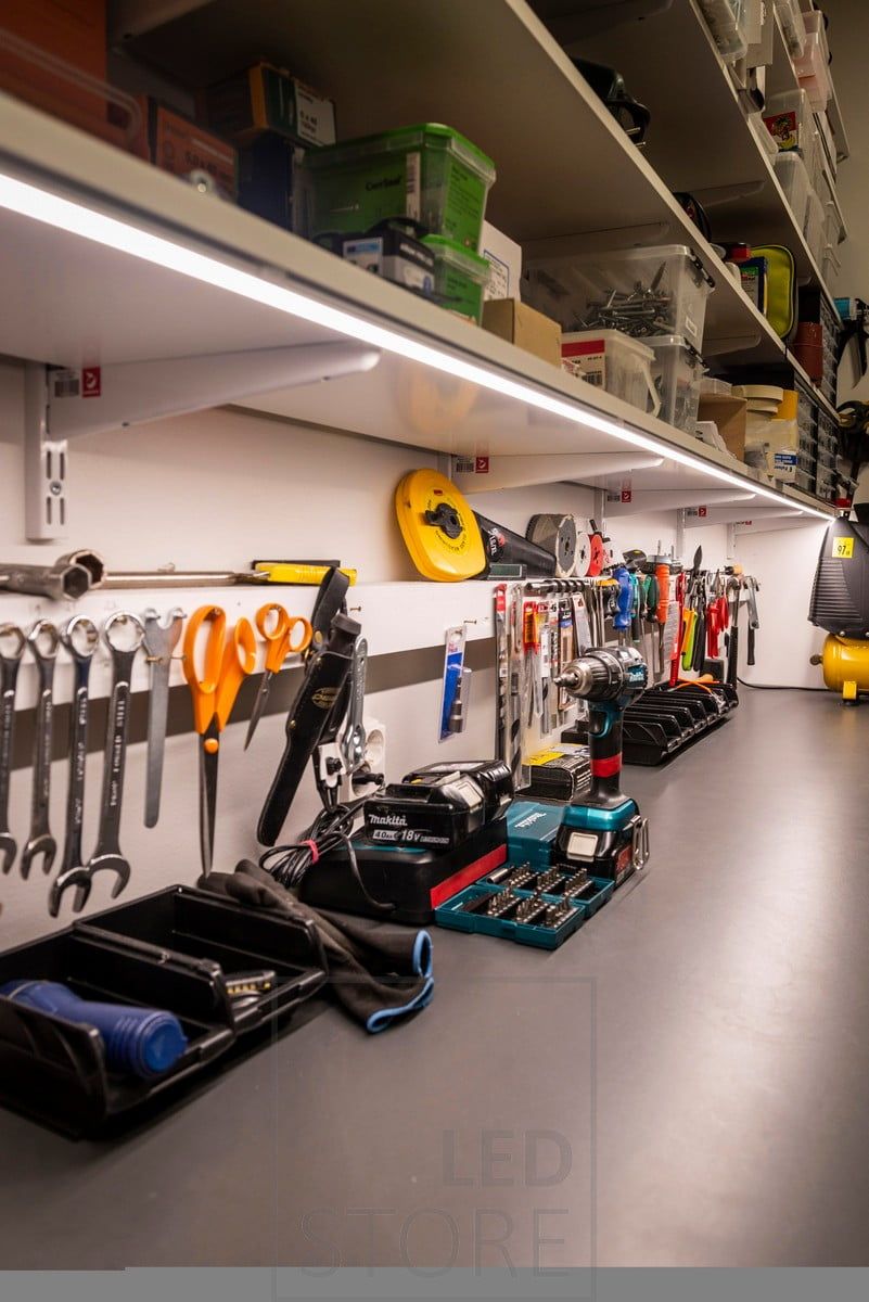 Led strip on the bottom of a shelf to illuminate a workstation in a warehouse. Ledstore.fi