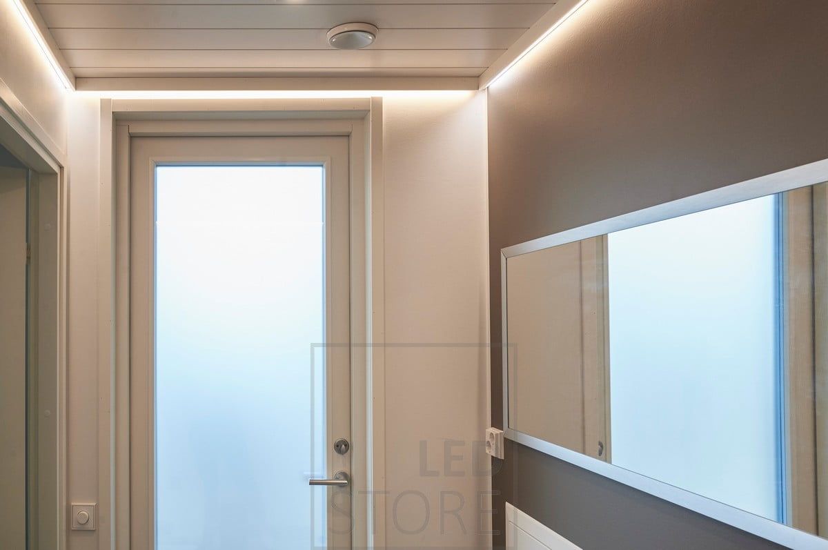 Indirect mood lighting in the hallway with a LED strip behind the ceiling strip. Ledstore.fi