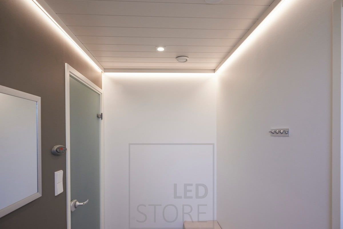 The hallway is illuminated by an indirectly illuminated LED strip behind the ceiling strip and a Fixed Cant spotlight. Ledstore.fi