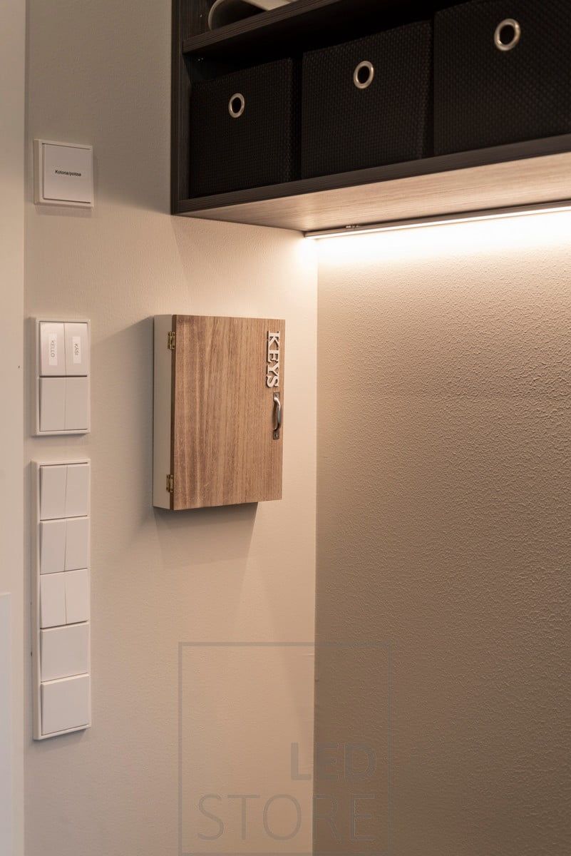 At the bottom of the upper cabinet in the hallway, a LED strip illuminates the hallway with atmospheric light. Ledstore.fi