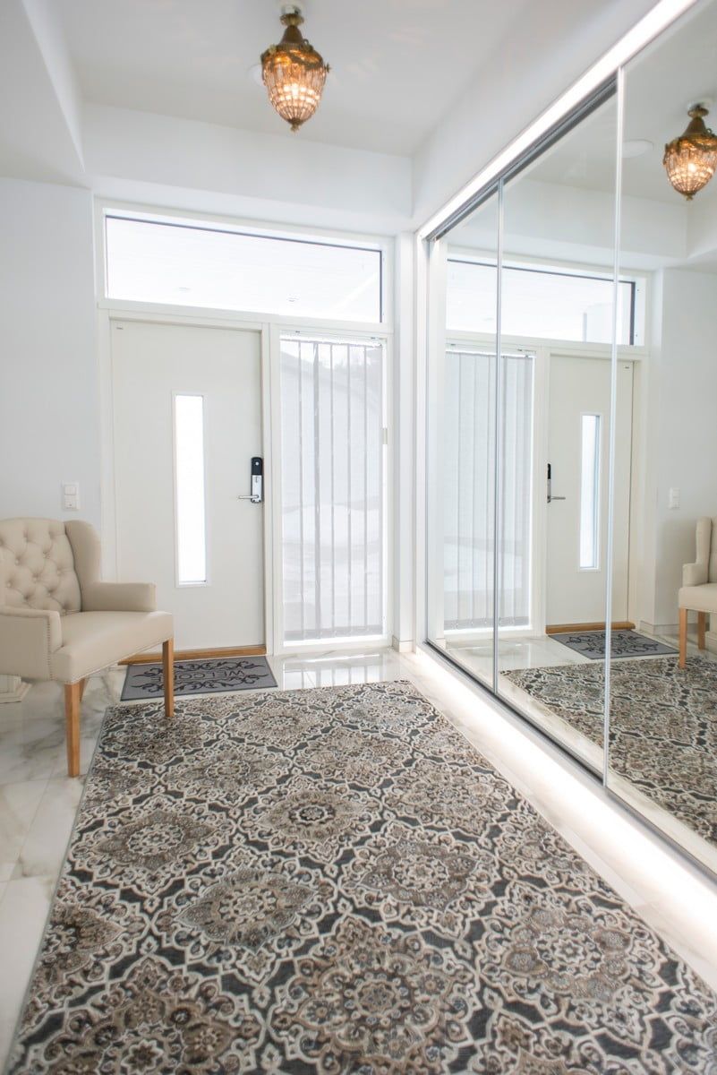 Entrance hall lighting with LED strips at the base of the cupboard and above the mirror in addition to the pendant light. Ledstore.fi