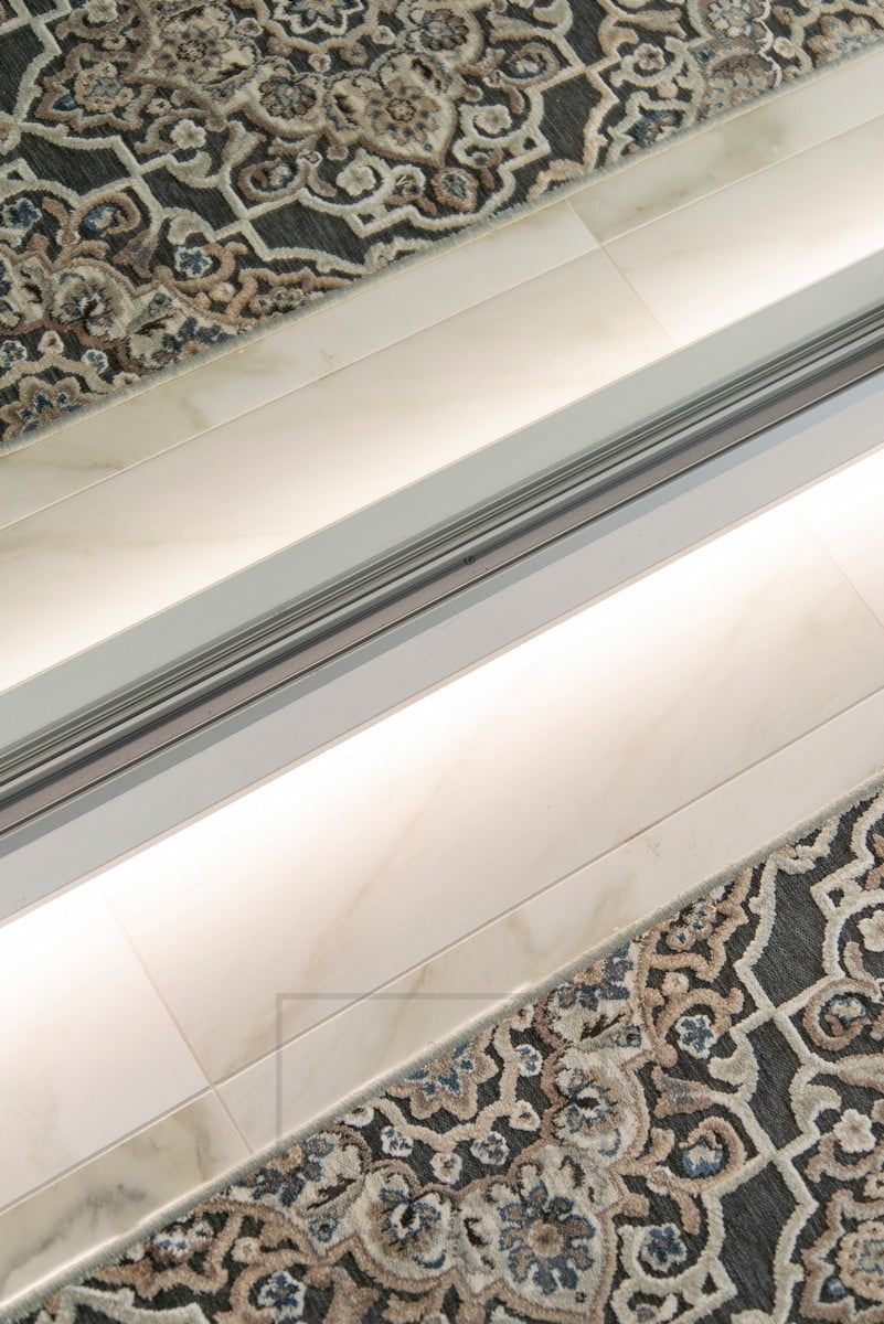 A LED strip at the base of the hallway cupboard provides indirect mood lighting to the hallway through the floor. Ledstore.fi