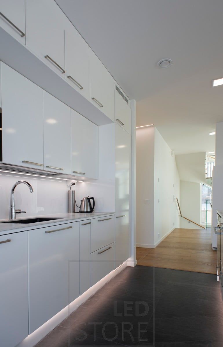 A LED strip in the kitchen plinth indirectly illuminates the floor with mood lighting. Ledstore.fi