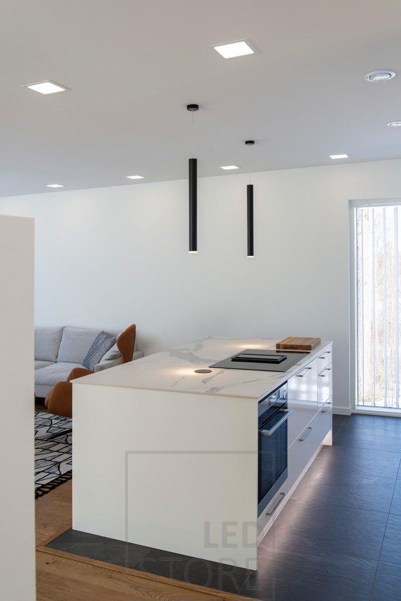 Chimney lamps as a decorative element on the top of an islet, a panel of 200 lamps on the ceiling and a led strip on the plinth. Ledstore.fi