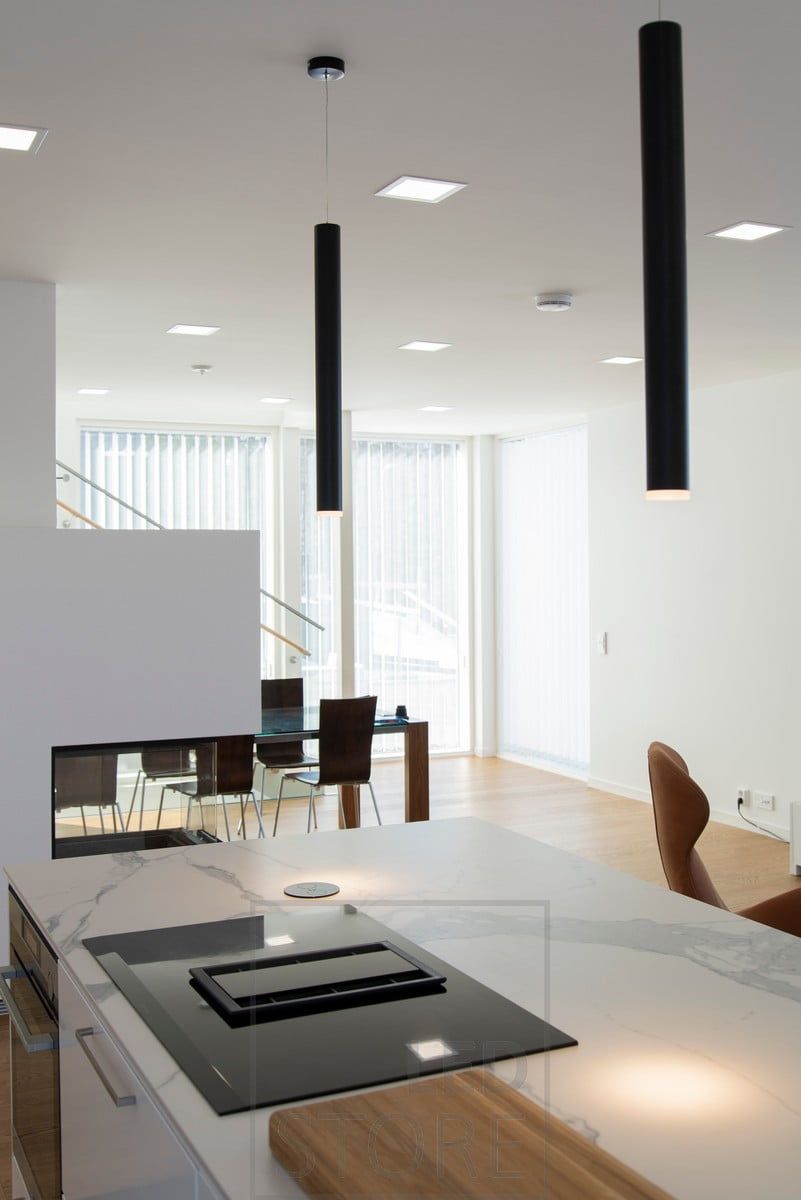 Panel of 200 luminaires on the ceiling, on top of an island of pendant pendant lights. Ledstore.fi