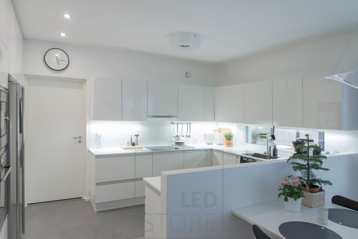 A LED strip attached to the base of the upper kitchen cabinets illuminates the worktops well, the spots act as corridor lights. Ledstore.fi