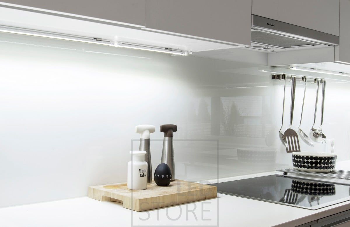 Narrow surface profile countertop light mounted on the base of a cabinet. Ledstore.fi