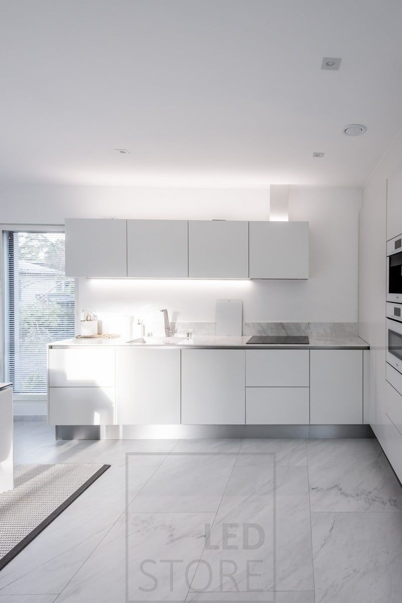 In the kitchen, an LED profile attached to the bottom of a cabinet and another LED profile providing indirect light on top of the cabinets. Ledstore.fi