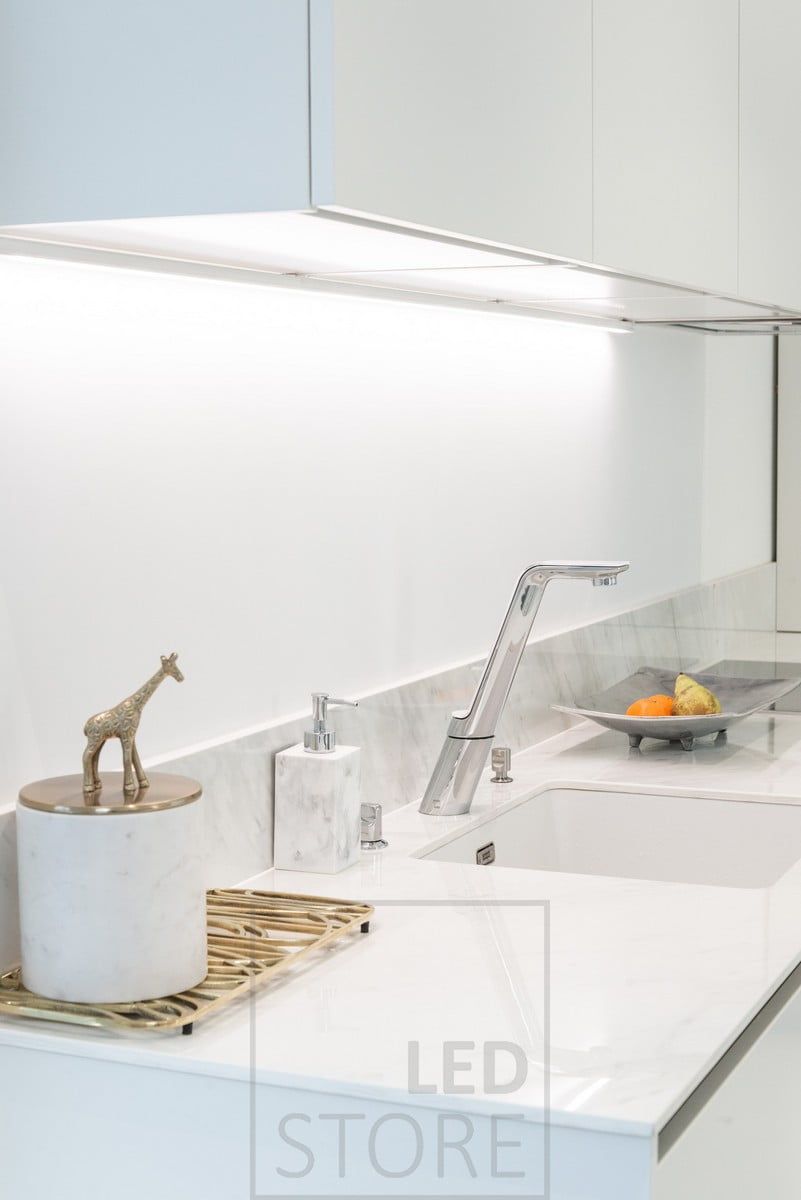 Kitchen flat lighting in the back corner of the cabinets, led strip fixed to the bottom of the cabinet in the surface profile. Ledstore.fi