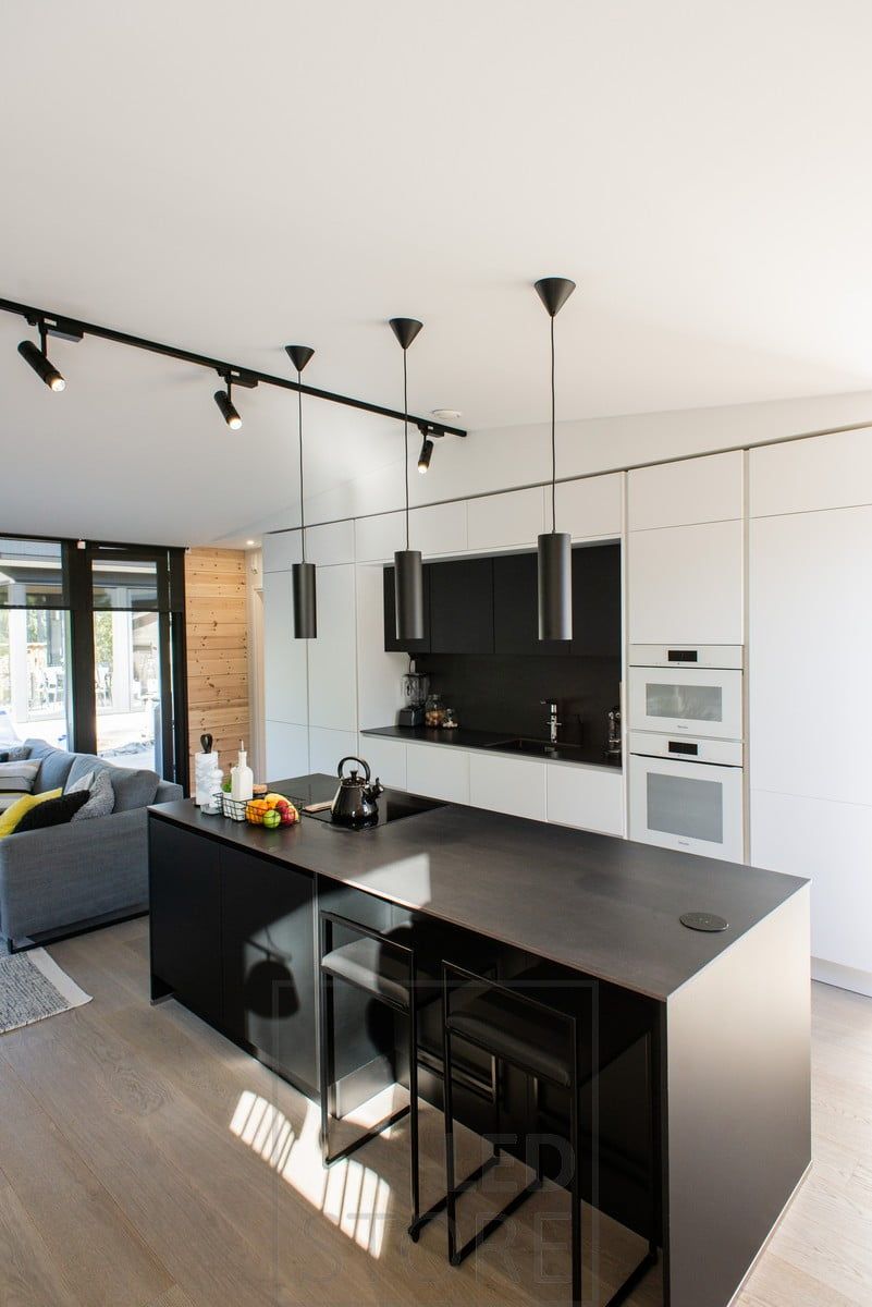 In the open kitchen and living room, rail-mounted spotlights provide general lighting, with pendant lights as interior lighting. Ledstore.fi