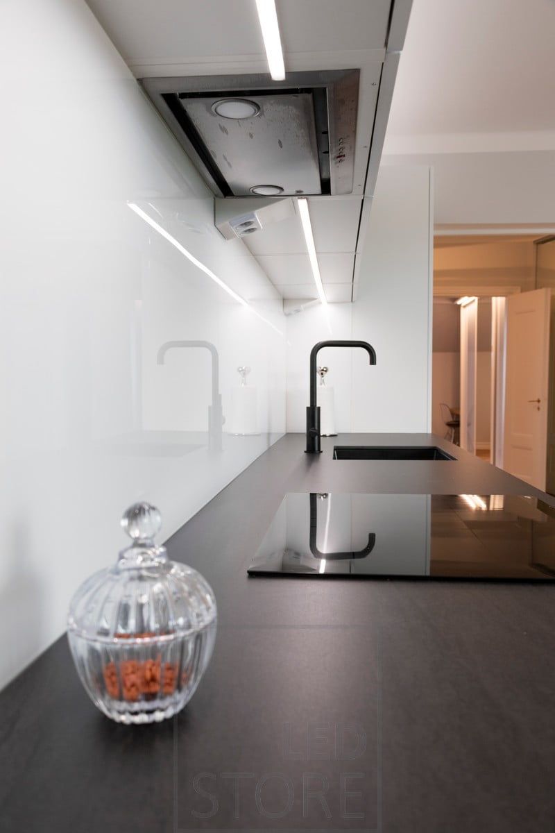 In the middle of the upper cabinets, a low profile LED strip illuminates the kitchen worktop. Ledstore.fi