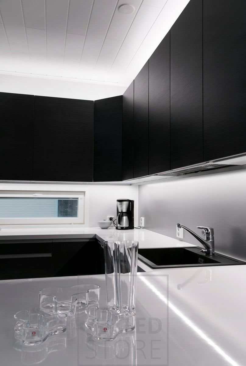 In the kitchen, LED strip lights on top of the cabinets and on the worktop. Ledstore.fi