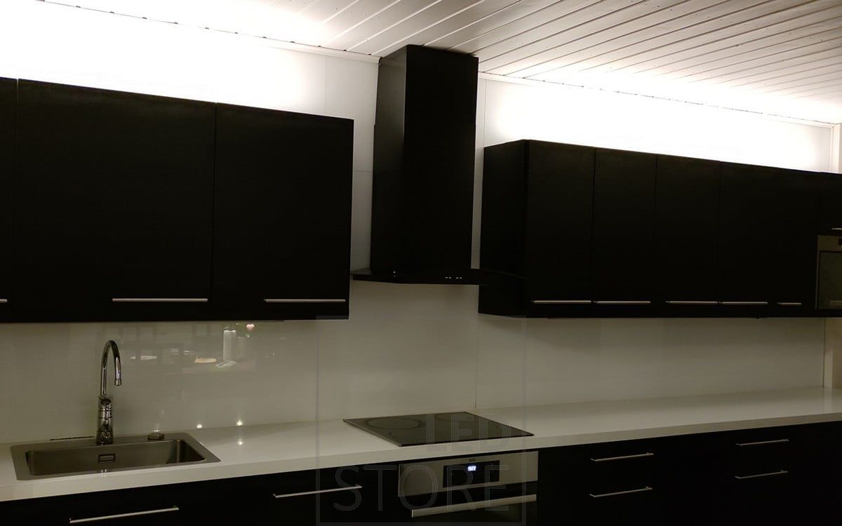 In the kitchen, LED strip lights above the upper cabinets provide atmospheric indirect light. Ledstore.fi