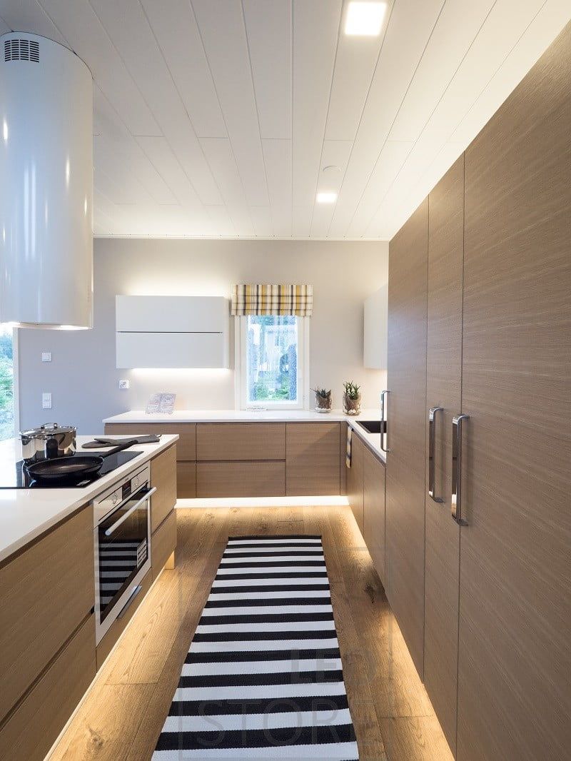 In the kitchen, LED strip lights on the plinth, on top of the cabinets and on the worktop. Ledstore.fi