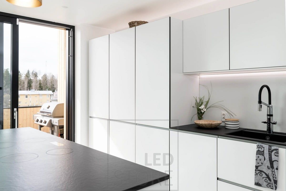 In the kitchen, flat lighting under the upper cabinets next to the wall. Indirect mood lighting above the cabinets. Ledstore.fi