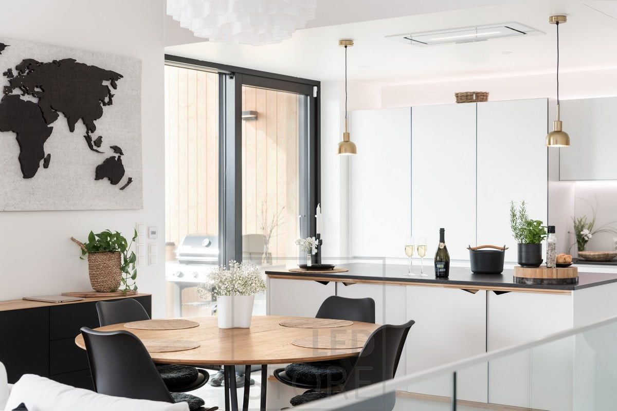 In the kitchen, LED strips on the bottom and top of the upper cabinets illuminate and support the light coming from the interior lamps. Ledstore.fi