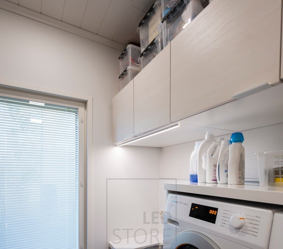 LED strip for extra light in the utility room, attached to the front edge of the cabinet. Ledstore.fi