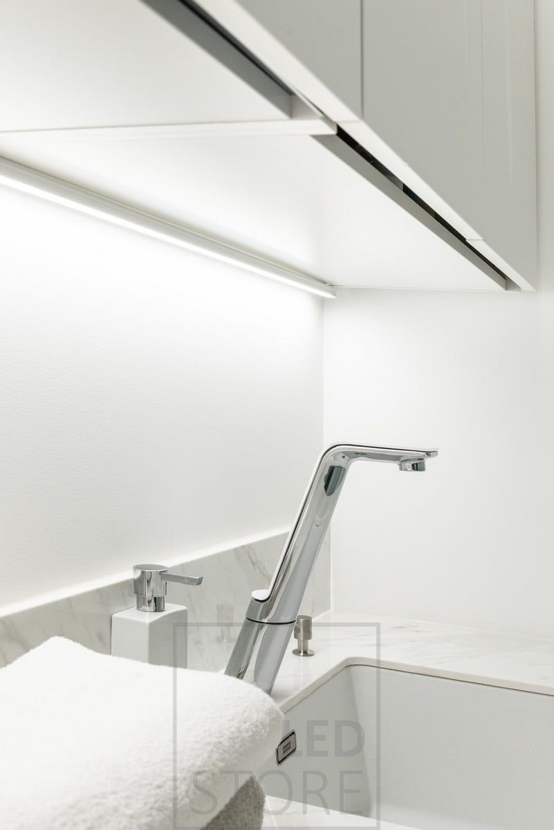 In the utility room, in the corner of the cupboard and the wall, in a high surface profile, an LED strip brings light to the level. Ledstore.fi