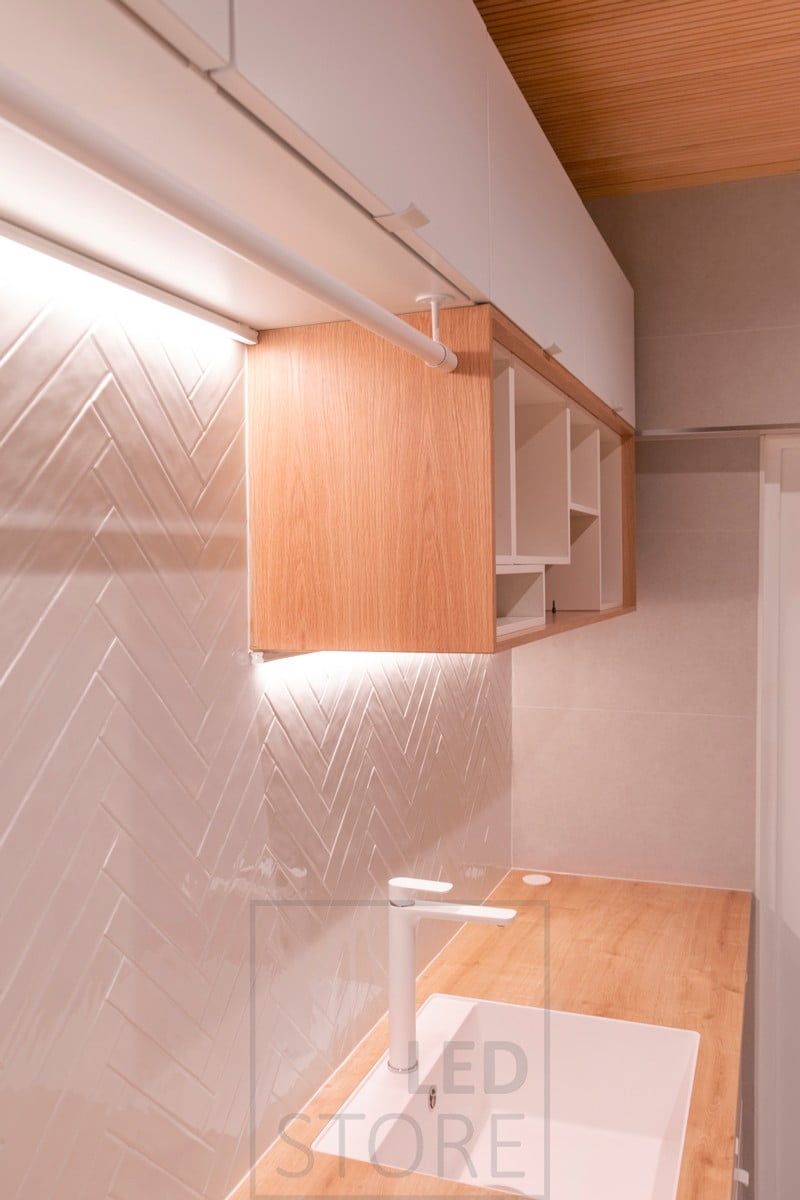 Two levels of led strip in the corner of the cabinet and the wall. Ledstore.fi