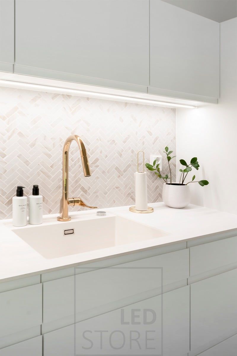 Lighting of a utility room worktop with LED strip mounted on a surface profile. Ledstore.fi